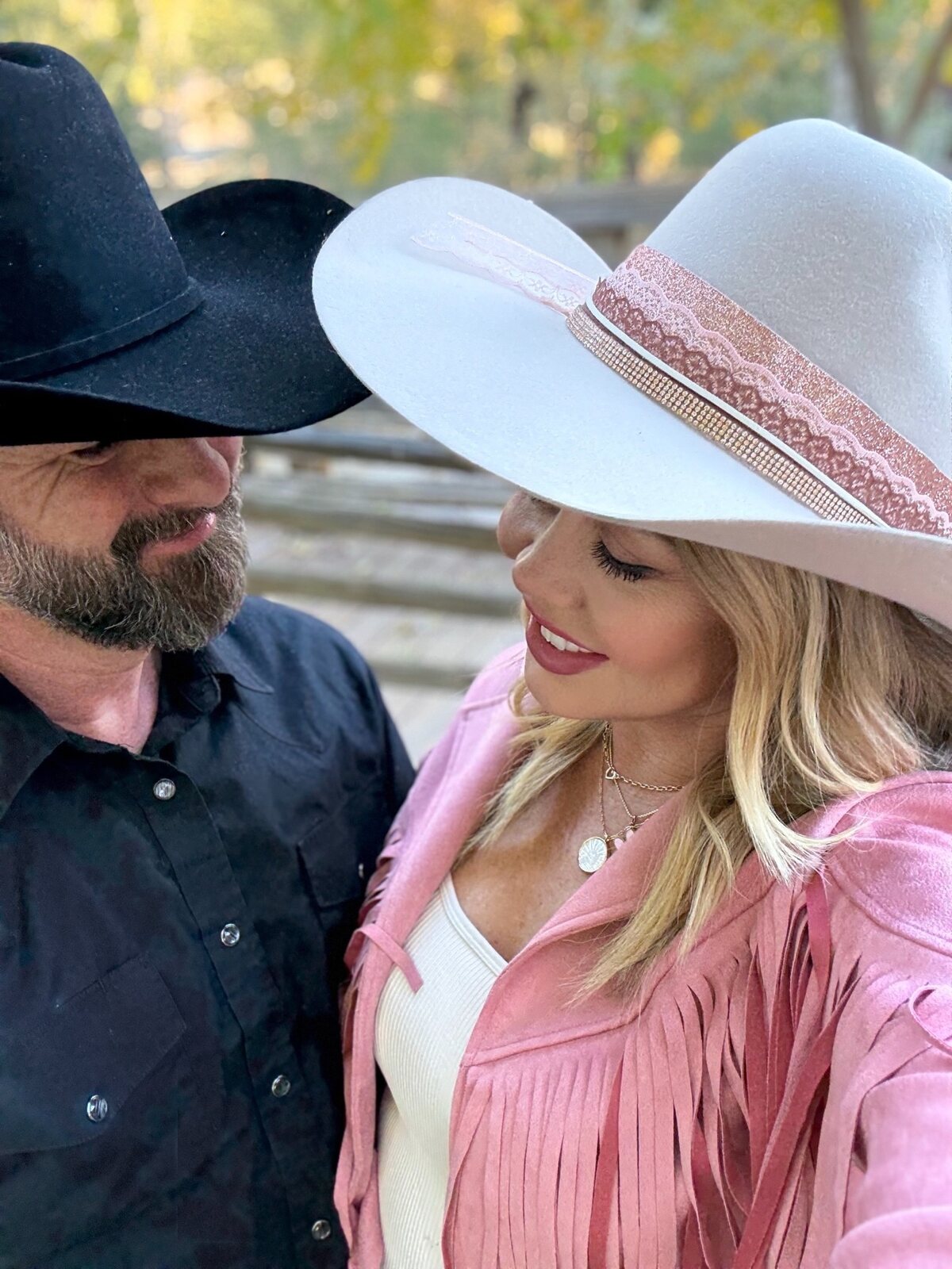 Couple wearing custom black and white cowboy hats